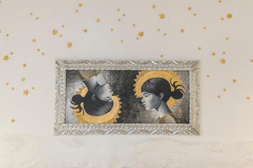 a painting of a woman and a girl on a wall at X.O Art House in Cusco