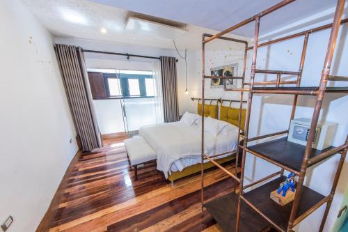 a bedroom with a bunk bed and a room with a window at X.O Art House in Cusco