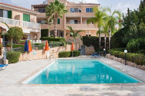 a swimming pool in front of a building at Top Seaview Apartment in Peyia in Peyia