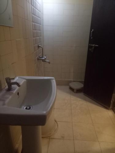a bathroom with a sink and a toilet at hotel sangeeth lodging in Mysore