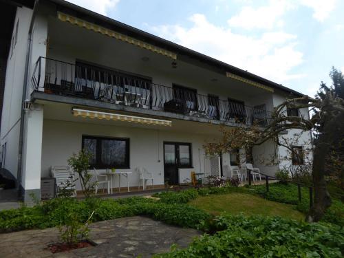 un edificio con sillas y mesas en el balcón en Ferienwohnung Dora 2, en Michelstadt