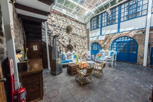 a living room with blue doors and chairs at X.O Art House in Cusco