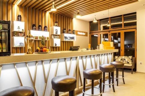 a bar in a restaurant with stools at Hotel Orlovetz in Pamporovo