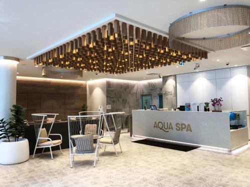 a lobby with chairs and a table and a chandelier at Tallink Spa & Conference Hotel in Tallinn