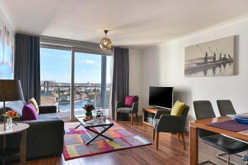 a living room with a view of a city at Fraser Place Canary Wharf in London