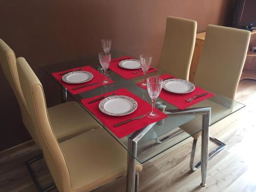 a dining table with glasses and plates on it at Apartmán Lipno in Lipno nad Vltavou