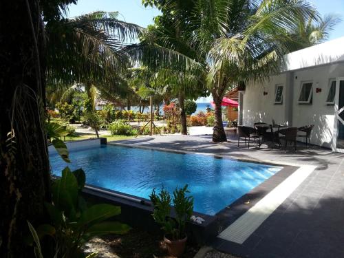 a swimming pool in the backyard of a villa at Binucot Beach Resort in Ferrol