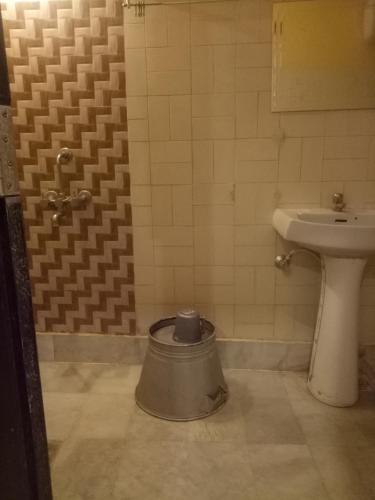 a bathroom with a toilet and a sink at hotel sangeeth lodging in Mysore