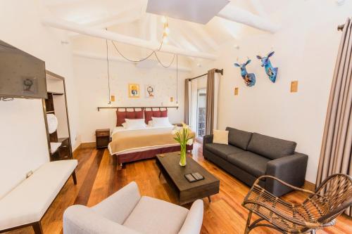 a living room with a bed and a couch at X.O Art House in Cusco