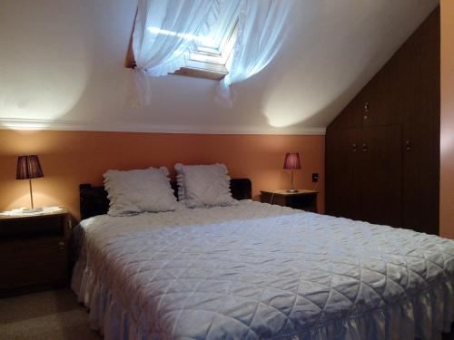 a bedroom with a large bed and a window at Üttörő út 177 B in Balatonfenyves