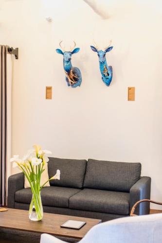 a living room with a couch and antlers on the wall at X.O Art House in Cusco