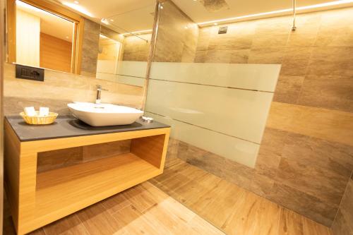 a bathroom with a sink and a shower at Hotel Centro's in Livigno