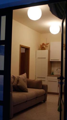 a living room with a couch and a kitchen at Arija in Bilice
