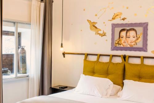 a bedroom with a bed with a yellow headboard and a window at X.O Art House in Cusco