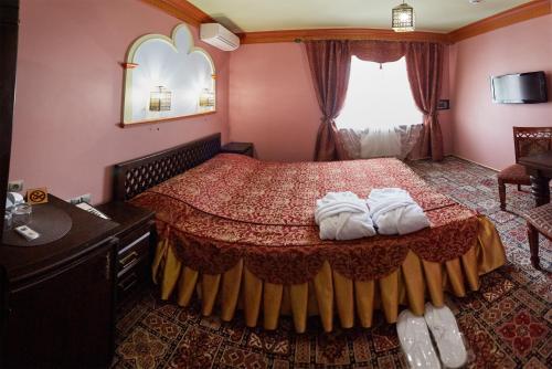 a bedroom with a bed with two towels on it at Pidkova in Rivne