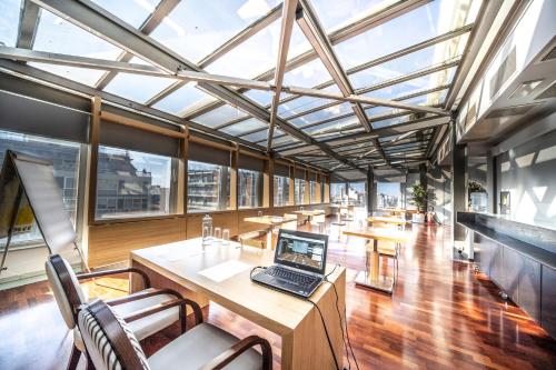 an office with a laptop on a wooden table at Egnatia Palace Hotel & Spa in Thessaloniki