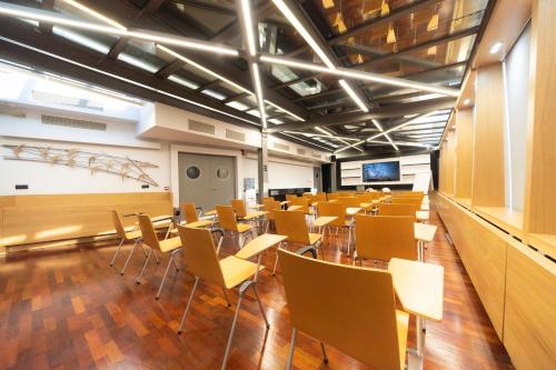 a large room with tables and chairs in it at Egnatia Palace Hotel & Spa in Thessaloniki