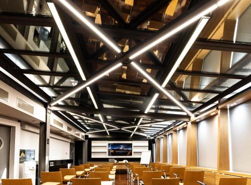 an empty lecture hall with chairs and a projection screen at Egnatia Palace Hotel & Spa in Thessaloniki