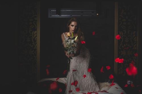 a woman in a dress holding a bouquet of flowers at Egnatia Palace Hotel & Spa in Thessaloniki