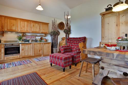 a kitchen with a couch and a chair and a table at Landvilla Pia in Attendorf