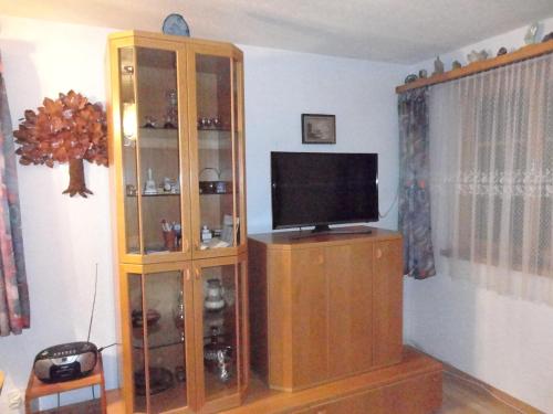 a wooden entertainment center with a television in a living room at Schweiz ,Lenk Ferienwohnung,Kinderfreundl,Seniorenfreundlich in Lenk