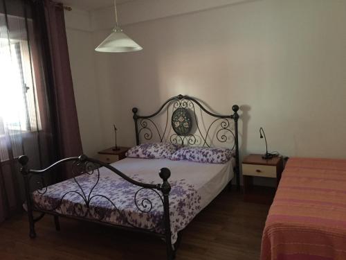 a bedroom with a bed with a wrought iron frame at Apartments Tajana in Novigrad Istria