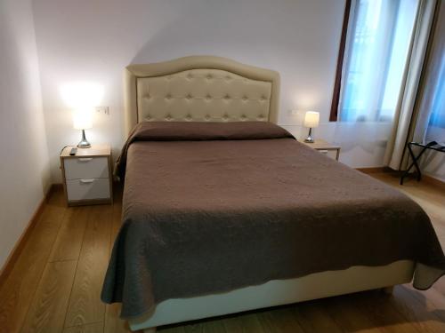 1 dormitorio con 1 cama grande y 2 mesitas de noche en San Polo Star, en Venecia