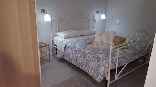a small bedroom with a bed and a chair at Afrodite suites deluxe in Agropoli