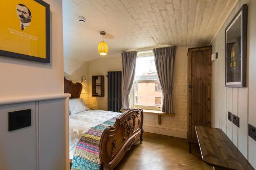 a bedroom with a bed and a window at McGettigan's Townhouse - Olives & Figs Bistro in Dublin