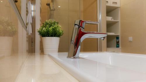 a bathroom with a sink and a faucet at Silent Home in Święta Katarzyna