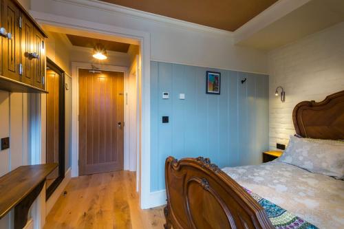 a bedroom with a bed and a desk in it at McGettigan's Townhouse - Olives & Figs Bistro in Dublin