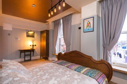 a bedroom with a bed in front of a window at McGettigan's Townhouse - Olives & Figs Bistro in Dublin