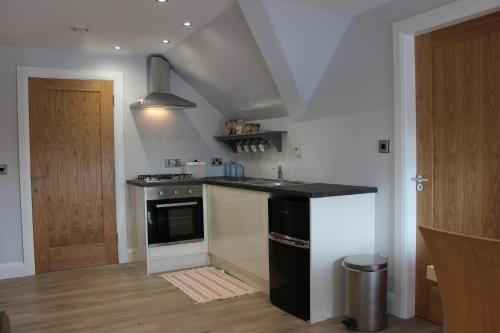a kitchen with a sink and a stove at Lakeside Studio 2 Loft Apartment in Enniskillen