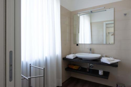 a bathroom with a sink and a mirror at L'Insolita Reggia in Caserta