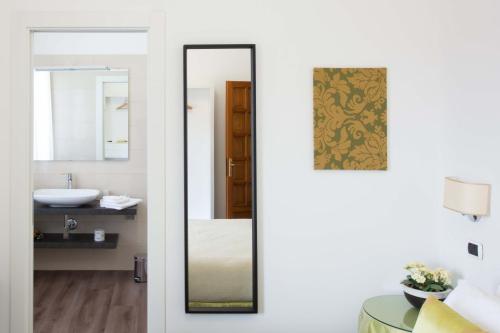 a bathroom with a mirror and a sink at L'Insolita Reggia in Caserta