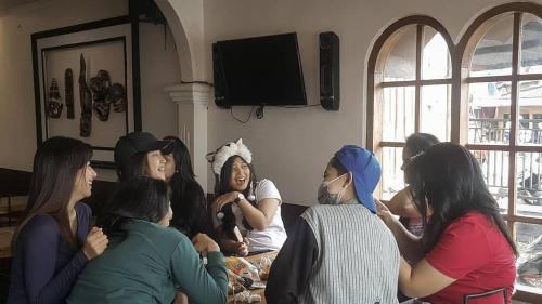 a group of women sitting on a couch together at Dieng Plateau Guest House in Diyeng