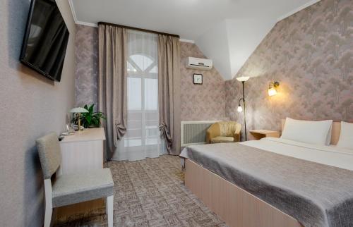 a hotel room with a bed and a window at Hotel Vizit in Cherepovets