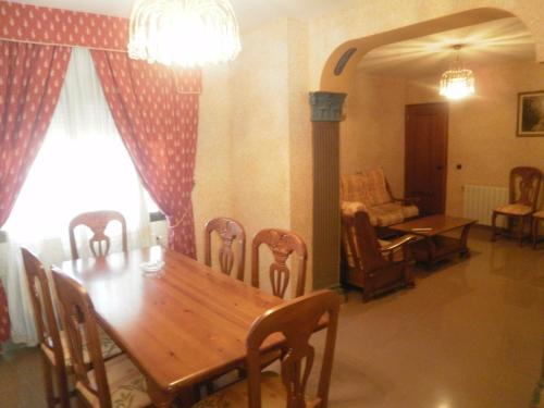 a dining room with a wooden table and chairs at Hostal Restaurante Solaire in Castañar de Ibor