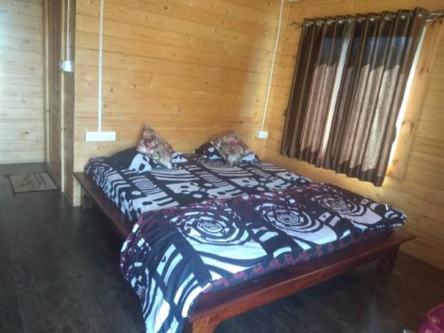 a bedroom with a bed in a wooden room at Trippr Chikkamagaluru in Chikmagalūr