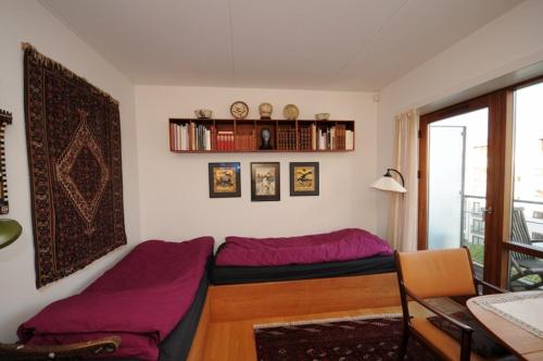 a living room with a bed and a table at Esben Juhls Guest Room in Copenhagen