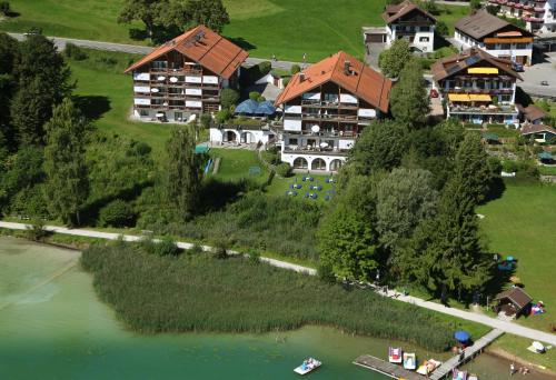 an aerial view of a house on an island in the water at Appartement-Hotel Seespitz in Füssen