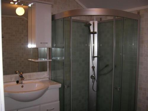 a bathroom with a shower and a sink at Presthus Gård in Ølve