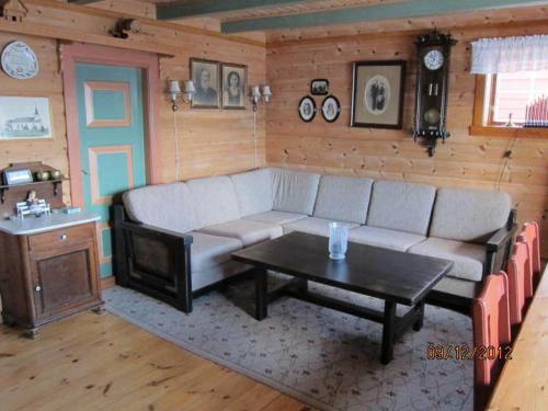 a living room with a couch and a table at Presthus Gård in Ølve