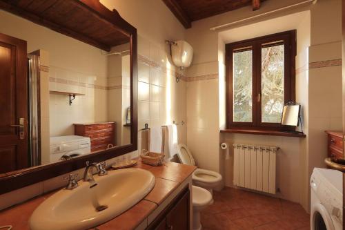 a bathroom with a sink and a toilet and a mirror at Ai due Cedri in Capranica