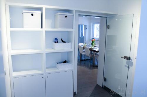 a room with white shelves and a dining table at Apartment Schanzenstraße 690 m ü. M in Winterberg