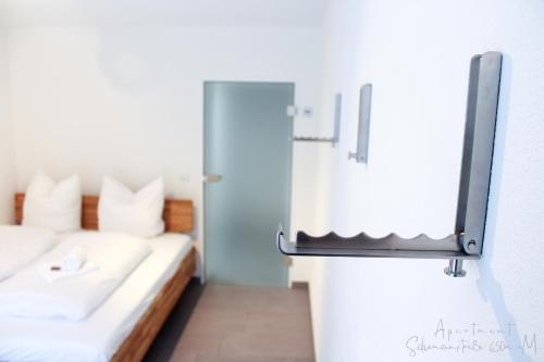 a small room with a bed and a mirror at Apartment Schanzenstraße 690 m ü. M in Winterberg
