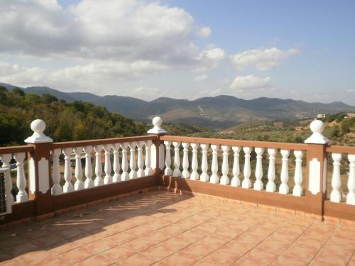 a balcony with a view of the mountains at Hostal Restaurante Solaire in Castañar de Ibor