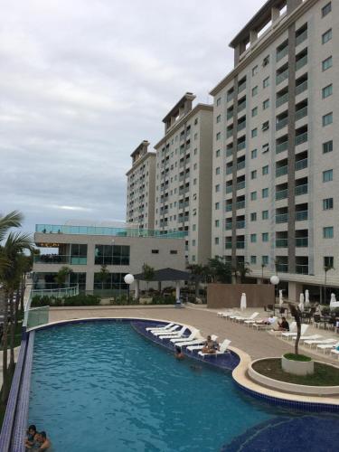 a large swimming pool in front of some buildings at Salinas Park Resort in Salinópolis
