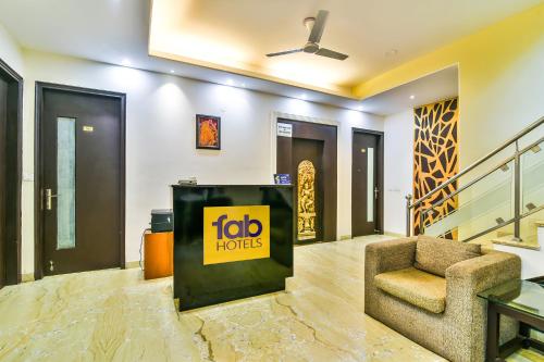 a hotel lobby with ako hotels sign on the floor at FabHotel Rallkmas Cyber City in Gurgaon