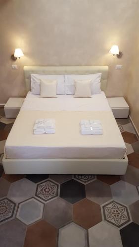 a large bed in a room with two towels on it at Appartamenti Borgo Panoramico N 4 in Tropea
